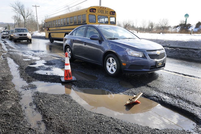 A series of potholes force traffic to go down to one lane along County Line Road near Trewigtown Road in Hatfield.