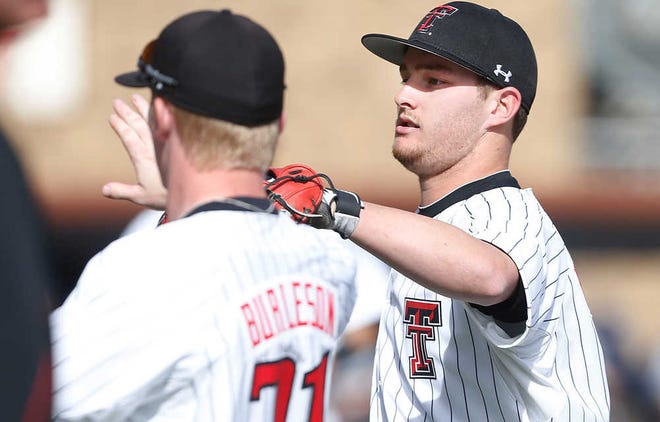 Texas Tech's Bryant Burleson(21) and Matt Broadbent celebrates the end of an inning without an Oral Roberts run during their game on Friday in Lubbock. (Stephen Spillman / AJ Media)