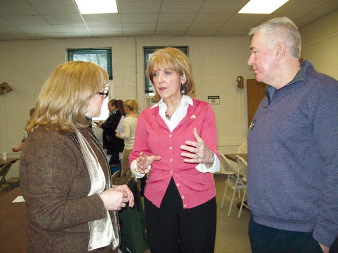 Attorney General Martha Coakley speaks with Susan Chalifoux Zephir at the Leominster Democratic Caucus on Saturday. Coakley’s husband Thomas O’Connor joins in the conversation.