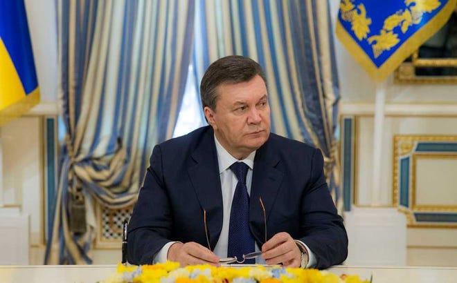 Ukrainian President Viktor Yanukovych attends the signing of an agreement to end the Ukrainian crisis in Kiev, Ukraine, Friday, Feb. 21, 2014. Ukraine's opposition leaders signed a deal Friday with the president and European mediators for early elections and a new government in hopes of ending a deadly political crisis. Russian officials immediately criticized the deal and protesters angry over police violence showed no sign of abandoning their camp in central Kiev. (AP Photo/Andrei Mosienko, Presidential Press Service, Pool)