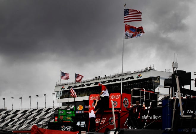 Crew members work on pit road under threatening skies during practice for 
Sunday's NASCAR Daytona 500 Sprint Cup series auto race in Daytona Beach on 
Friday.
ASSOCIATED PRESS / TERRY RENNA