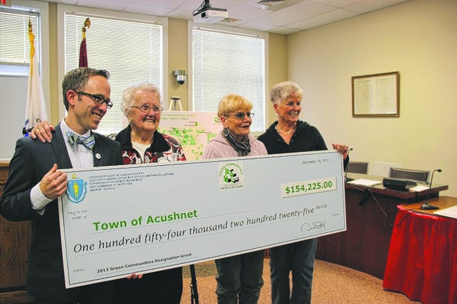 State officials presented Acushnet with a Green Communities Award Wednesday, but the real stars were the family members of Mark Sylvia, Commissioner of the state Department of Energy Resources (left). Shown with him (left to right) are his grandmother, Therese Ledoux, age 96, a 64-year resident of Acushnet; aunt Flo Hathaway of Acushnet; and Juliette Baker, his mother's twin sister, of Lakeville.
