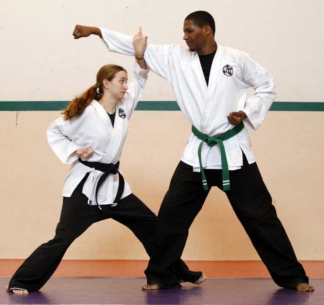 DARON.DEAN@STAUGUSTINE.COMCaitlin Bassett, left, practices techniques with Ishmel Brown while training at Koryo Do on Saturday morning, February 22, 2014.