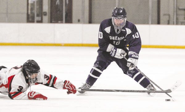Old Rochester/Fairhaven defender Mason Evitch dives to the ice in an effort to slow down a Somerset-Berkley attacker.