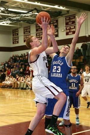 Dundee’s # 4 Justin Brace goes in for a lay-up despite the Oakfield-Alabama defender.