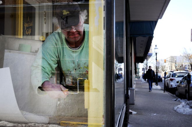 Norm Bailey, of River Valley Contractors, paints the interior of the soon-to-be Nina's Waffles and Sweets on State Street in Doylestown Borough on Monday morning. Owner Louis Zanias described the store as an old style ice-cream parlor with a twist. The local shop is expected to open in early April.