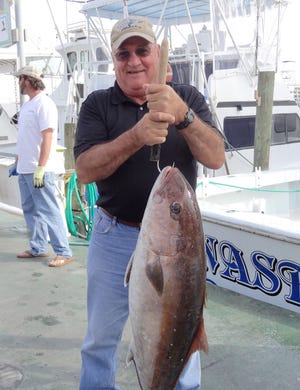 Terry Turcotte of Canada shows off his 40-plus pound amberjack he caught Monday aboard the Anastasia with Capt. Tony Davis.