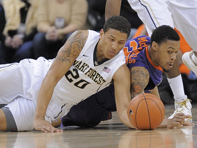 Wake Forest's Miles Overton (20) battles Clemson's K.J. McDaniels for a loose ball during the first half on Tuesday night in Winston-Salem, N.C.
