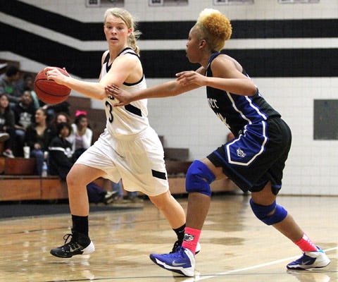 Havelock's Natalie Johnson, left, tries to drive around Fayetteville Westover's Kirsten Jackson during a first-round playoff game on Monday at Havelock High. Johnson scored 14 points as the Rams won the game 69-39.