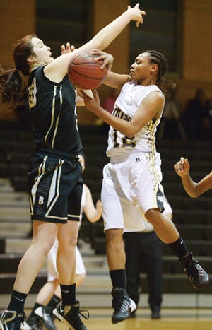 Williams High School's Jada Kelly, right, slides a pass around Gray's Creek's Amber Tyndall during Monday night's game.