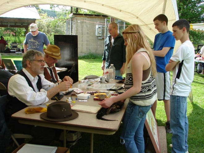 Visitors at a past Fishing Heritage Day in South Otselic enjoy a fly-tying demonstration as one of the many events held throughout the day. This year's event is set for Saturday, May 17.
