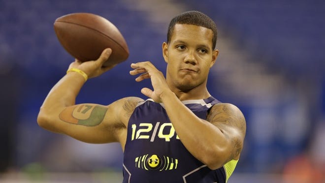 Miami quarterback Stephen Morris throws during a drill at the NFL football scouting combine in Indianapolis, Sunday, Feb. 23, 2014. (AP Photo/Michael Conroy)