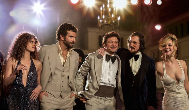 This film image released by Sony Pictures shows, from left, Amy Adams, Bradley Cooper, Jeremy Renner, Christian Bale and Jennifer Lawrence in a scene from “American Hustle.” This year’s best picture race at the 86th Academy Awards on Sunday, March 2, 2014, has shaped up to be one of the most unpredictable in years. The favorites are “12 Years a Slave,” “Gravity” and “American Hustle.”