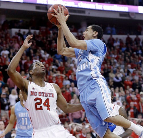 North Carolina point guard Marcus Paige drives to the basket for the winning shot in overtime as N.C. State forward T.J. Warren defends.