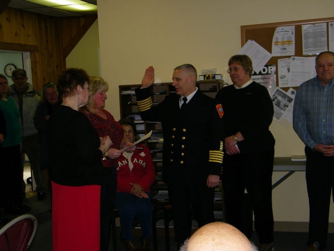 Michael Sitar Jr., being sworn in as the new fire chief of the Tilton-Northfield Fire & EMS Department in Tilton, N.H., on Saturday, Feb. 22. Sitar’s wife Malenie was with him to pin his new badge to his uniform. District Clerk Katina Lemay is reading the oath and Fire Commission Chairman Paul Auger is standing in the background. Courtesy photo