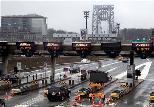 In this Jan. 11, 2014, file photo, traffic passes through the toll booths at the George Washington Bridge, in Fort Lee, N.J. On paper, David Wildstein's title at the Port Authority of New York and New Jersey was "Director of Interstate Capital Projects." But many who worked there knew his real job, a post created just for him in 2010, was to further Republican Gov. Chris Christie's agenda inside the agency.He led efforts to give New Jersey officials more sway over authority operations. Now, the man who was known as the administration's eyes and ears at the Port Authority may be the public's best chance of knowing the truth behind a plan last summer to purposely create days of traffic gridlock in Fort Lee, N.J., by choking off local access to the George Washington Bridge.(AP Photo/Richard Drew, File)