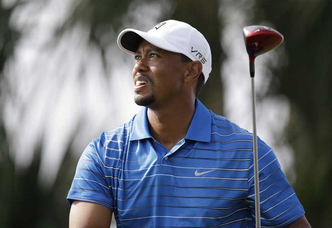 Golfer Tiger Woods watches his tee shot on the 18th hole during the first round of the Honda Classic golf tournament, Thursday, Feb. 27, 2014 in Palm Beach Gardens, Fla. (AP Photo/Wilfredo Lee)