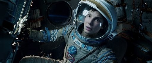 This film image released by Warner Bros. Pictures shows Sandra Bullock in a scene from "Gravity." This year's best picture race at the 86th Academy Awards on Sunday, March 2, 2014, has shaped up to be one of the most unpredictable in years. The favorites are "12 Years a Slave," "Gravity" and "American Hustle." (AP Photo/Warner Bros. Pictures, File)