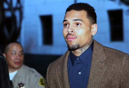 FILE - In this Feb. 3, 2014 file photo, R&B singer Chris Brown arrives at a Los Angeles Superior Court for a probation review hearing in Los Angeles. A judge ordered Chris Brown on Friday, Feb. 28, 2014, in Los Angeles, to remain in an anger management rehab program and told the pop singer to return to court in two months. Superior Court Judge James Brandlin scheduled the next hearing in Brown's case for April 23, 2014. (AP Photo/Nick Ut, file)