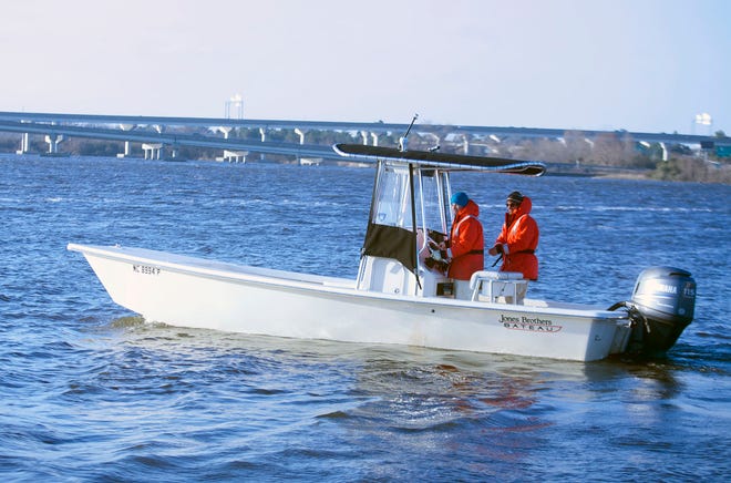Jeffrey Dobbs, left, and Zachary Fasking, technician observers with the Division of Marine Fisheries, pilot their boat from Union Point Park in New Bern to begin a day on the river to observe large and small gillnet fishing.
