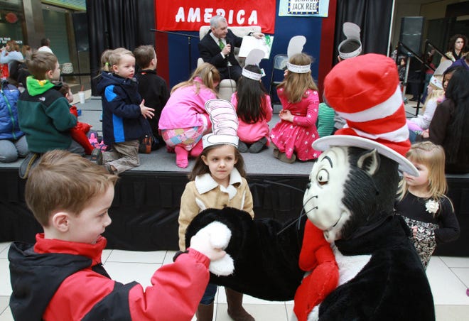 "The Cat" greets Kolby Daun, 6, of East Greenwich, and Olivia Rodrigues, 5, of Warwick, as U.S. Sen. Jack Reed reads to kids at the 17th Read Across America Celebration at the Warwick Mall on Saturday.