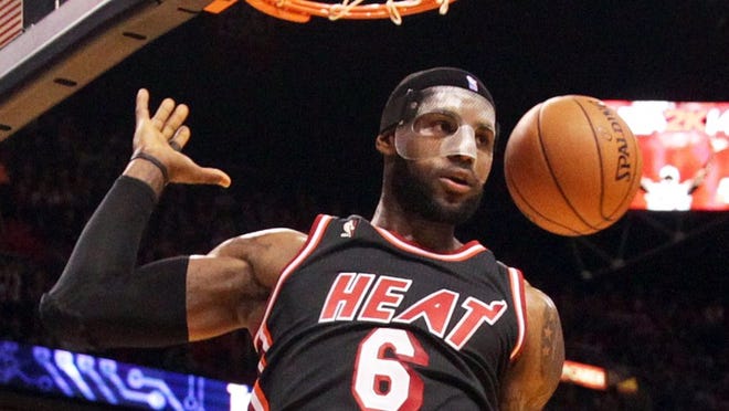 The Miami Heat's LeBron James dunks in the first quarter against the Orlando Magic at AmericanAirlines Arena in Miami on Saturday, March 1, 2014. (Pedro Portal/El Nuevo Herald/MCT)
