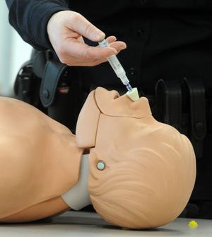 Stoughton Police Sgt. Donna McNamara, demonstrates how to administer Narcan.