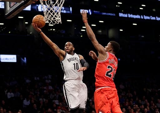 Brooklyn Nets' Marcus Thornton, left, shoots past Chicago Bulls' Jimmy Butler during the first half of an NBA basketball game Monday, March 3, 2014, in New York. (AP Photo/Seth Wenig)