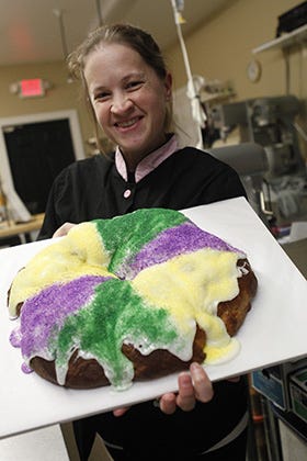 Emily Asnes, lead baker at White Oak Bakery, with a King Cake - a Mardis Gras tradition - in the kitchen of White Oak Bakery in Jacksonville, Monday afternoon.