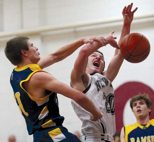 Photo by Daniel Freel/New Jersey Herald - Newton's Chris Guth, right, is blocked by Ramsey's Mike Pepper in their North 1, Group 2 first-round state playoff game Tuesday night in Newton.