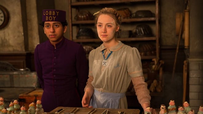 Tony Revolori, left, and Saoirse Ronan in star in Wes Anderson’s “The Grand Budapest Hotel.”