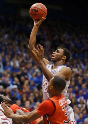 Kansas guard Andrew Wiggins (22) shoots over Texas Tech forward Jaye Crockett (30) during the first half of an NCAA college basketball game in Lawrence, Kan., Wednesday, March 5, 2014. (AP Photo/Orlin Wagner)