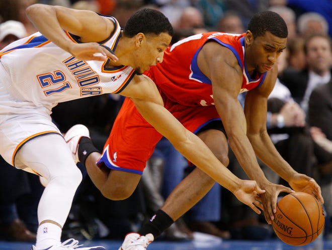 Oklahoma City's Andre Roberson (21) and Philadelphia's Hollis Thompson (31) go for a loose ball during an NBA basketball game between the Oklahoma City Thunder and the Philadelphia 76ers at Chesapeake Energy Arena in Oklahoma City, Tuesday, March 4, 2014. Oklahoma City won 125-92. Photo by Bryan Terry, The Oklahoman