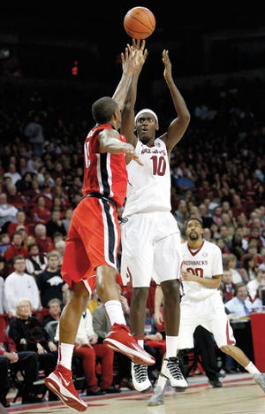 Marc F. Henning * Arkansas News Bureau Arkansas' Bobby Portis shoots over Georgia's Donte' Williams during the second half of the Razorbacks' game Saturday, March 1, 2014, against the Bulldogs at Bud Walton Arena in Fayetteville.