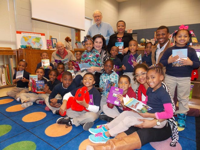 Rotarians Bill Edwards, Dave Dubreuil, Robyn Penn Delaney and DeRon Talley present books to the Donaldsonville Primary School students and principal Mary McMahan and Assistant Principal Dr. Tenneil Lange.