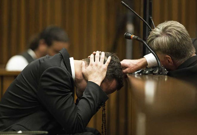 Marco Longari Associated Press Oscar Pistorius puts his hands to his head while listening to evidence in court Thursday. The former Olympic sprinter is charged with the murder of his girlfriend.