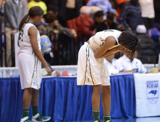 Kinston's Takerian Harper covers her face after the final buzzer sounded in Wednesday's season-ending loss in the Eastern Regionals to T.W. Andrews. The Vikings came up on the losing end of an emotional 57-56 finish.