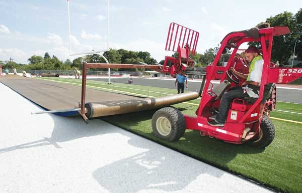File photo by Daniel Freel/New Jersey Herald In a 2012 file photo, Neal Amiruddin, a worker with Athletic Fields of America of Montville, uses a forklift to lay down a new synthetic turf field at the Newton High School football field.