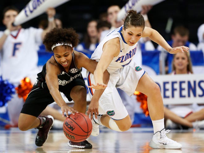 Mississippi State guard Katia May, left, and Florida guard Carlie Needles chase down a loose ball in the first half of a second-round women's Southeastern Conference tournament game Thursday in Duluth, Ga. (AP Photo/John Bazemore)