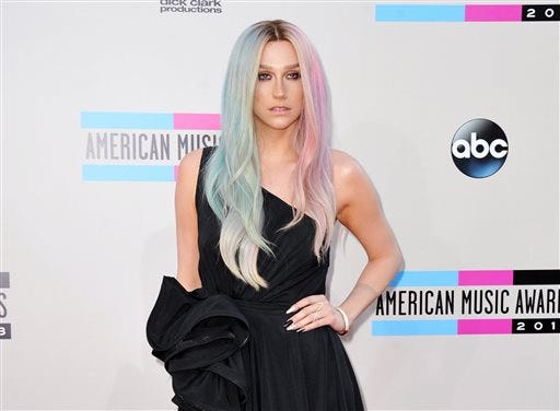 FILE - This Nov. 24, 2013 file photo shows musician Ke$ha at the American Music Awards at the Nokia Theatre L.A. Live in Los Angeles. Ke$ha's representative confirmed Friday, March 7, 2014, that the singer checked out of rehab. She entered in January. The 26-year-old vegetarian said she entered rehab to "learn to love myself again, exactly as I am." Ke$ha, whose real name is Kesha Rose Sebert, is the performer of such tunes as "Crazy Love," ''Die Young" and "Timber" with Pitbull. (Photo by Jordan Strauss/Invision/AP, File)