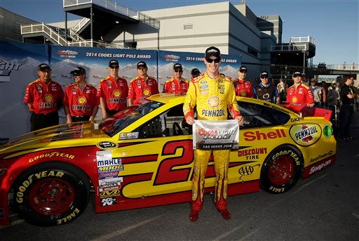 Joey Logano poses for photos after winning the pole position for Sunday's NASCAR Sprint Cup Series auto race, Friday, March 7, 2014, in Las Vegas.