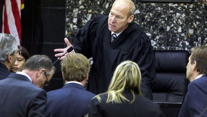 Chief Circuit Judge Jeffrey Colbath talks with attorneys during a bench conference during a hearing regarding John Goodman’s Bentley Thursday, March 6, 2014. Goodman is at right (Lannis Waters / The Palm Beach Post)