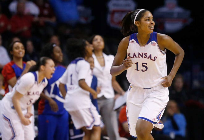 Kansas forward Chelsea Gardner (15) smiles as she runs upcourt following a basket in the second half of a Big 12 women's NCAA college basketball tournament game against Kansas State in Oklahoma City, Friday, March 7, 2014. Kansas won 87-84 in overtime.
