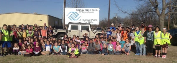The Boys and Girls Club of Brown County gathered for a photo with the 2001 H1 Hummer, for which raffle tickets are currently being sold. The drawing will be held during the annual Barn Dance, May 3, along with live and silent auctions.