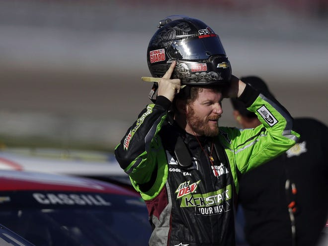 Dale Earnhardt Jr. puts on his helmet during qualifying for Sunday's NASCAR Sprint Cup Series race Friday in Las Vegas.
