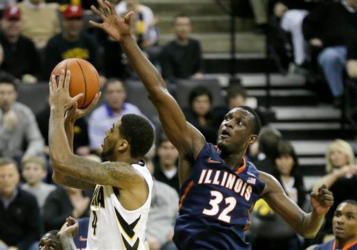 Illinois center Nnanna Egwu, right, tries to block a shot by Iowa guard Devyn Marble during the second half of an NCAA college basketball game on Saturday, March 8, 2014, in Iowa City, Iowa. (AP Photo/Charlie Neibergall)