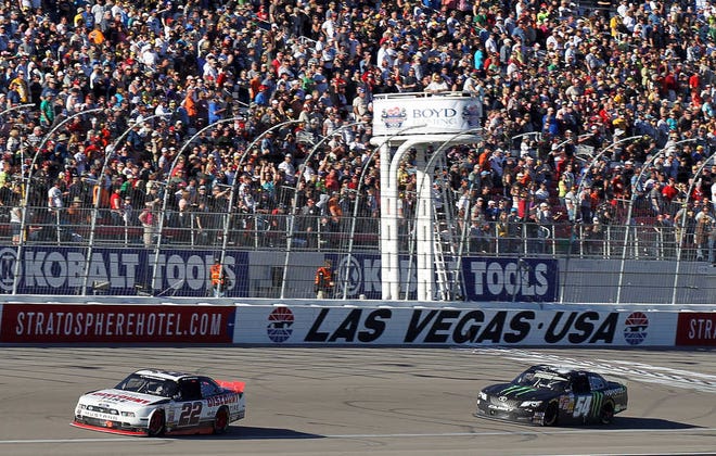 Brad Keselowski (22) leads Kyle Busch (54) during the NASCAR Nationwide Series auto race Saturday, March 8, 2014, in Las Vegas. Keselowski won the race. (AP Photo/Isaac Brekken)