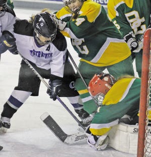 Al Pike/Foster’s Daily Democrat
Oyster River High School’s Maggie McNamara (left) looks for a rebound as Bishop Guertin goalie Mia Vecchione covers up the puck during Division I playoff action Friday night in Durham.