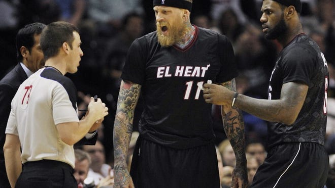 Miami Heat forward Chris Andersen, center, argues with official Kevin Scott, left, as Heat forward LeBron James looks on during the second half of an NBA basketball game against the San Antonio Spurs, Thursday, March 6, 2014, in San Antonio. San Antonio won 111-87. (AP Photo/Darren Abate)