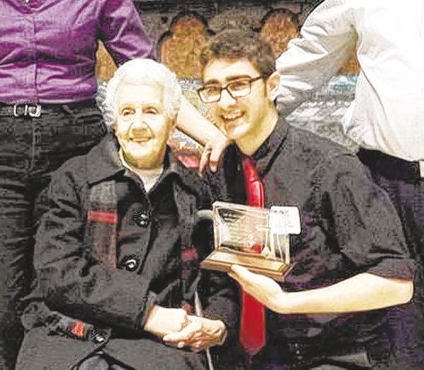 Courtesy photo
Alice Santos, grandmother and Confirmation sponsor, smiles proudly as Michael Santos, a Bishop Stang junior, poses with his St. Timothy Award in Providence March 2.